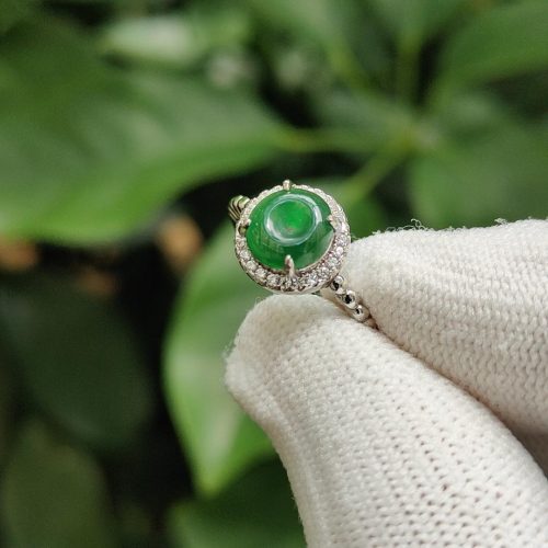 a hand wearing a glove with a ring