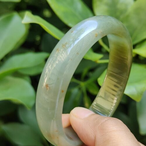 a hand holding a bracelet