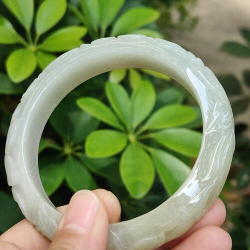 a hand holding a white circular object