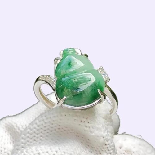 a ring with a green stone on it