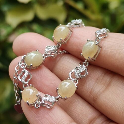 a hand holding a bracelet