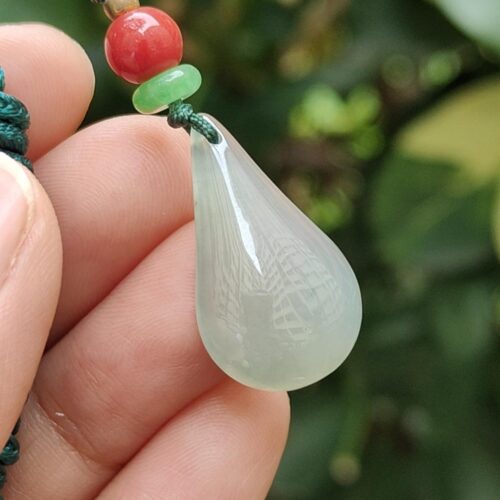 a hand holding a necklace