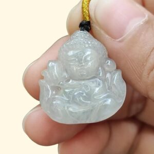 a hand holding a small white stone pendant
