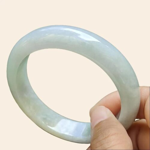 a hand holding a white ring