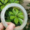 a hand holding a jade ring