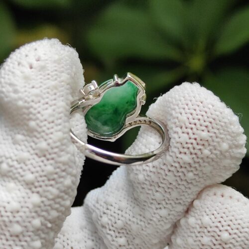 a gloved hand holding a ring