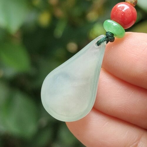 a hand holding a necklace