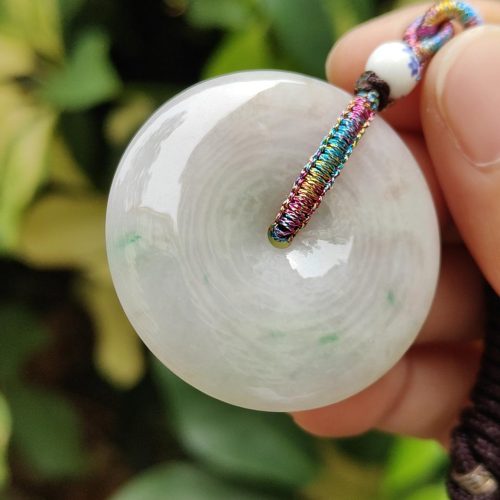 a hand holding a white round object