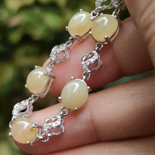 a hand holding a bracelet