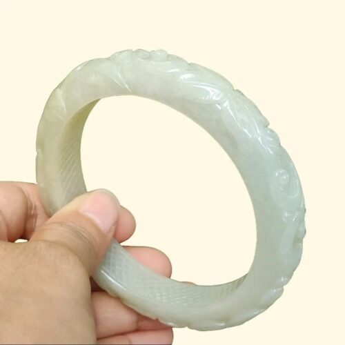 a hand holding a white circular object