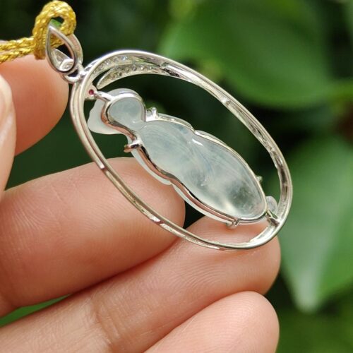 a hand holding a necklace