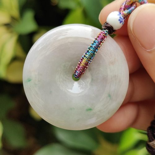 a hand holding a white round object