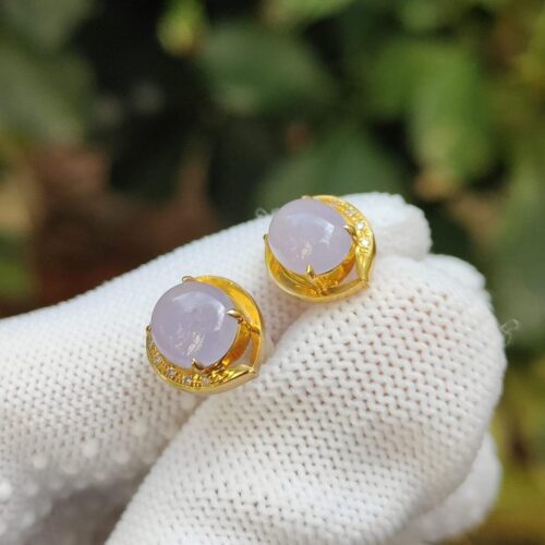 a pair of earrings on a glove