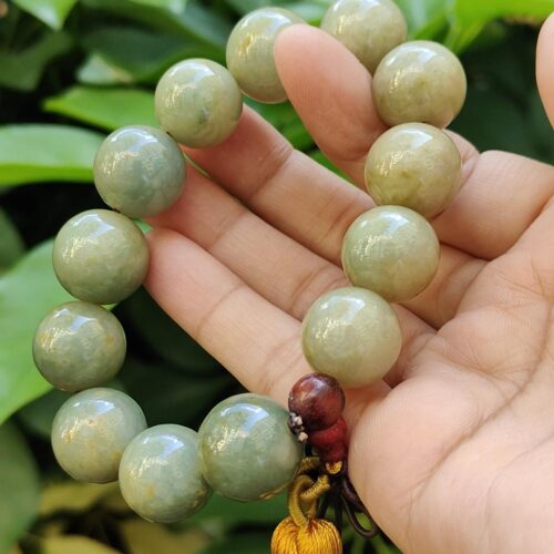 a hand holding a beaded necklace