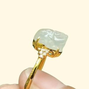 a finger holding a ring