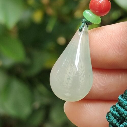 a hand holding a necklace