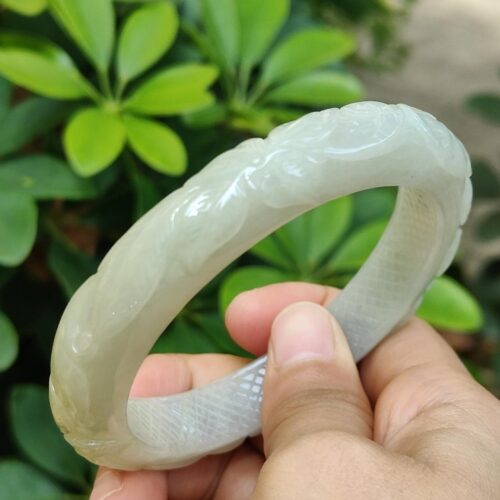 a hand holding a white bracelet