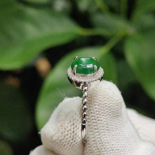 a hand wearing a glove with a ring