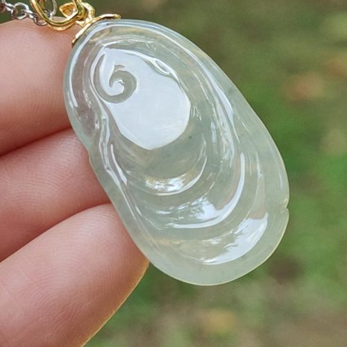 a hand holding a necklace