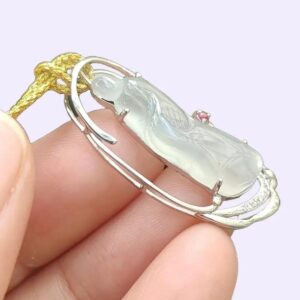 a hand holding a pendant