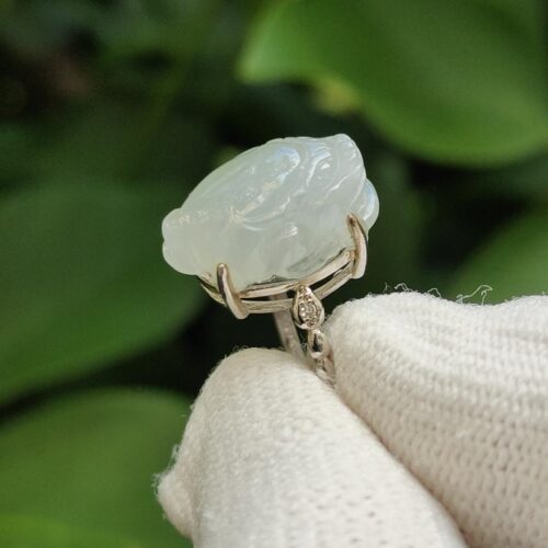 a hand holding a white gloved finger