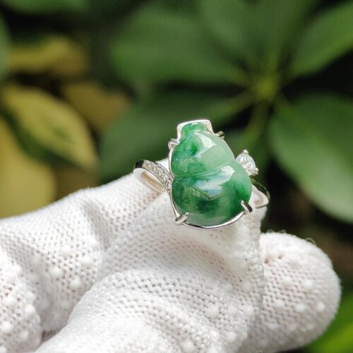 a hand wearing a glove with a ring