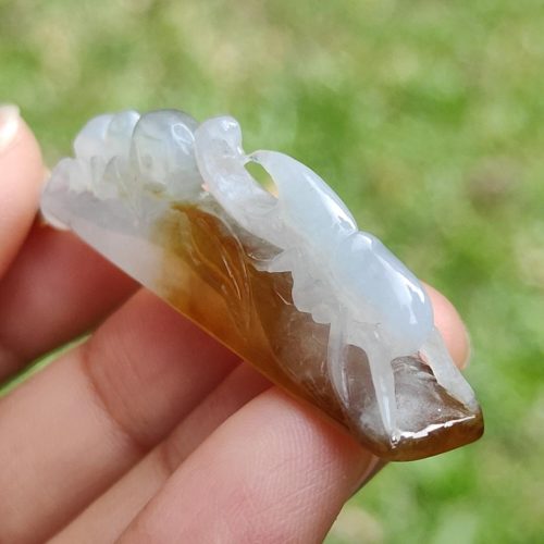 a hand holding a stone sculpture