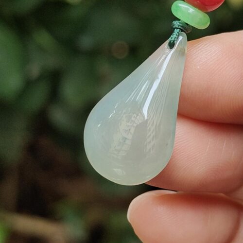 a hand holding a necklace