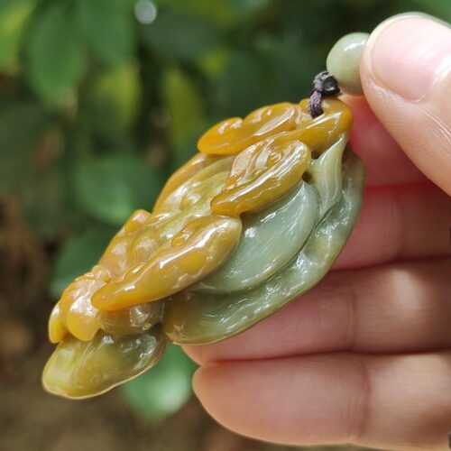 a hand holding a piece of jewelry