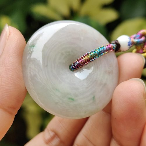 a hand holding a white round object