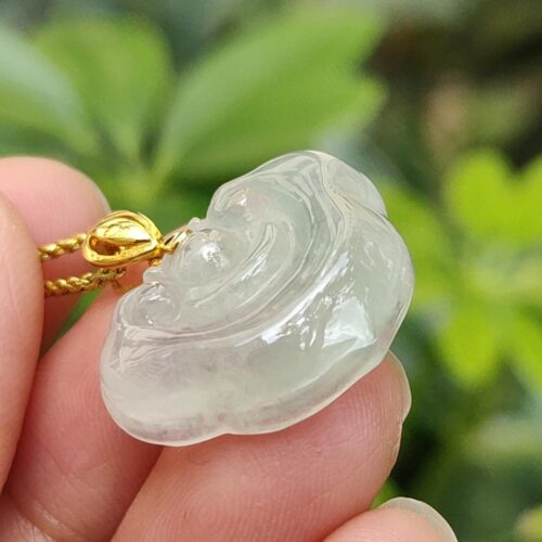 a hand holding a clear plastic necklace