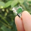 a finger holding a ring- Green Pixiu Ring