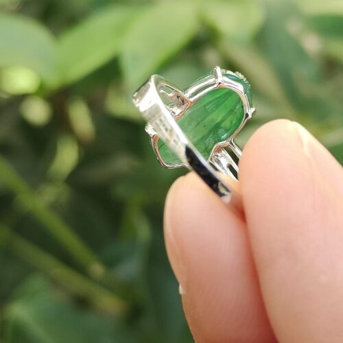 a finger holding a ring- Green Pixiu Ring