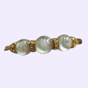 a gold ring with white stones