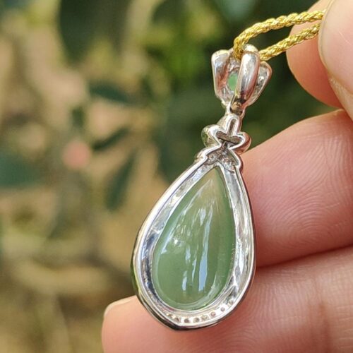 a hand holding a necklace