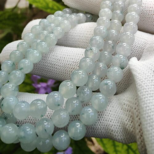 a hand holding a string of beads