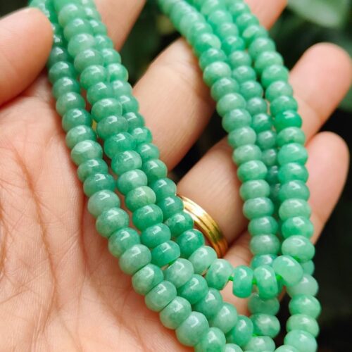 a hand holding a necklace