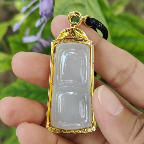 a hand holding a pendant