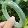 a hand holding a green bracelet
