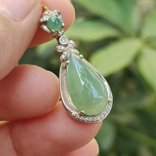 a hand holding a pendant