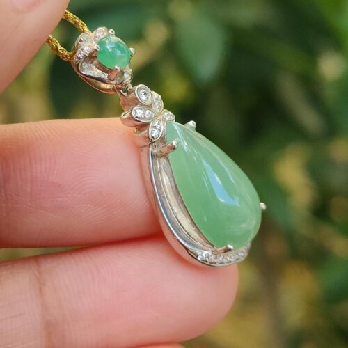 a hand holding a necklace