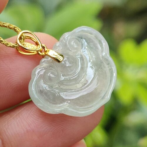 a hand holding a necklace