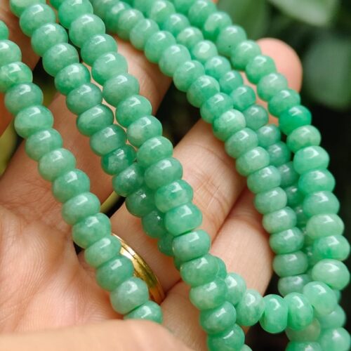 a hand holding a necklace