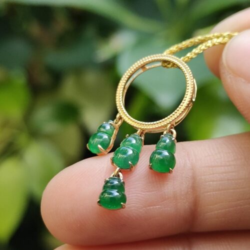 a hand holding a necklace