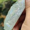 a hand holding a piece of jade