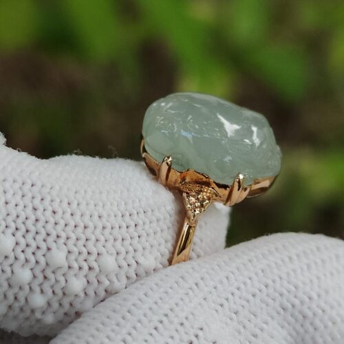 a hand wearing a white glove with a ring on it