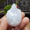 a hand holding a white jade