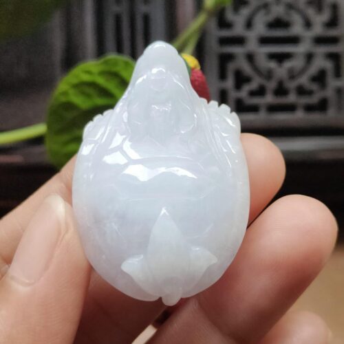 a hand holding a white jade