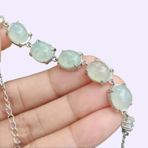 a hand holding a bracelet