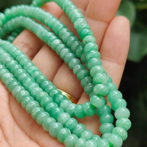 a hand holding a necklace